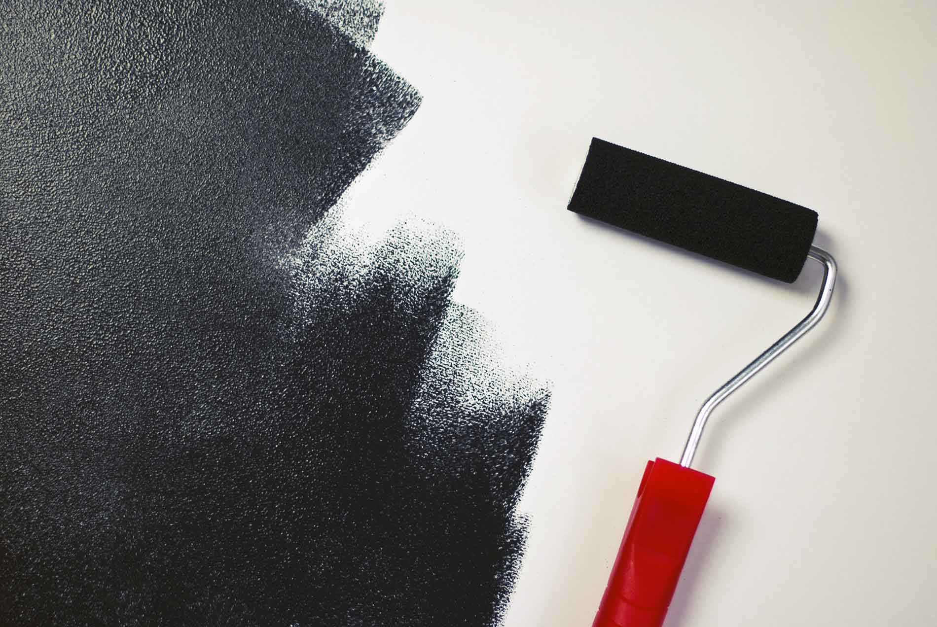 red paint roller with black paint