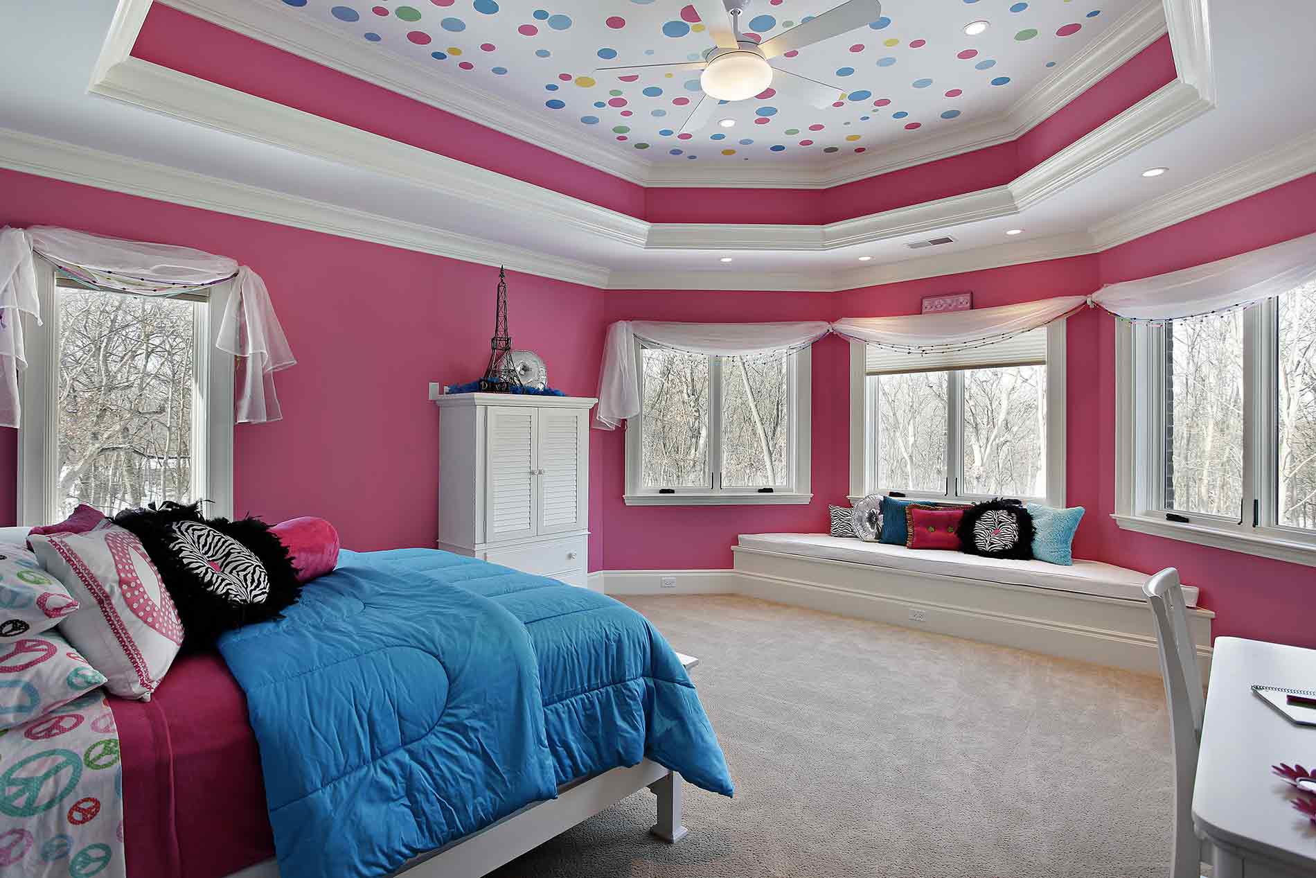 a bedroom with pink walls