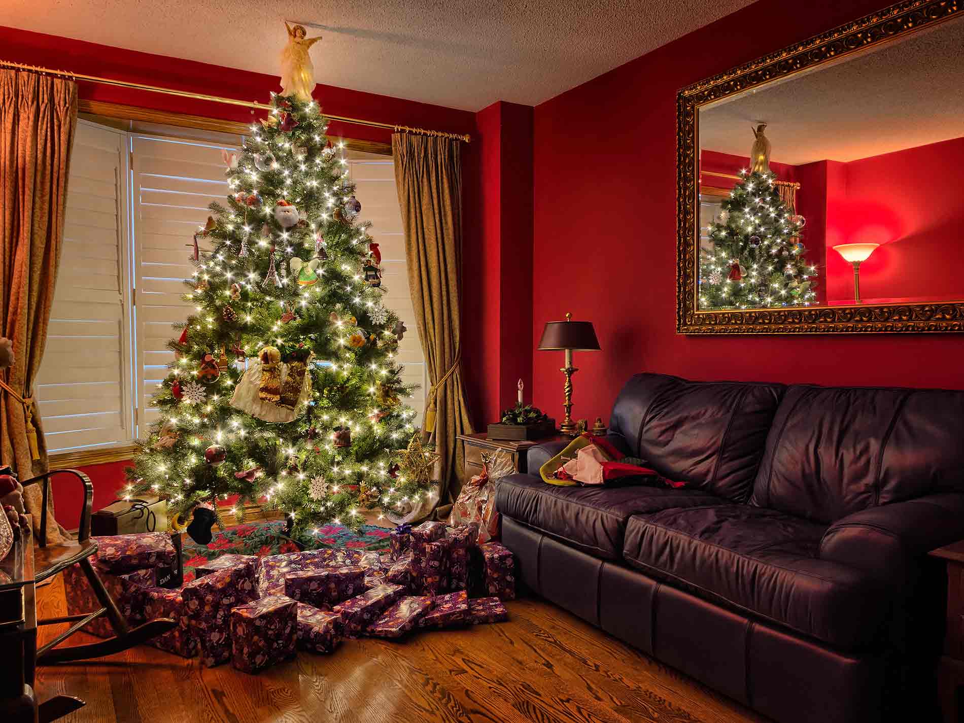 red living room with a couch and Christmas tree